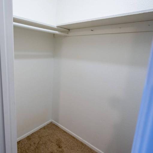 A small, empty room with a carpeted floor.
