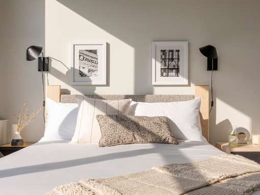 Bedroom with white comforter at Lofts at Centennial Yards, Atlanta, 30303