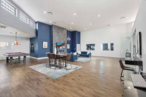 A modern living room with a dining table and chairs.