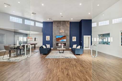 A modern living room with a fireplace and a dining area.