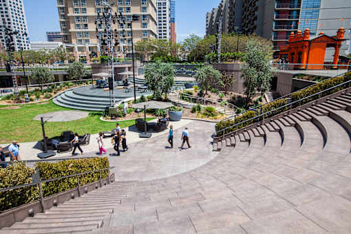 A group of people are walking up a set of steps in a park.