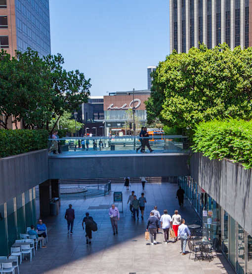A group of people are walking through a pedestrian area.