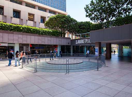 A shopping mall with a fenced off area in the middle.