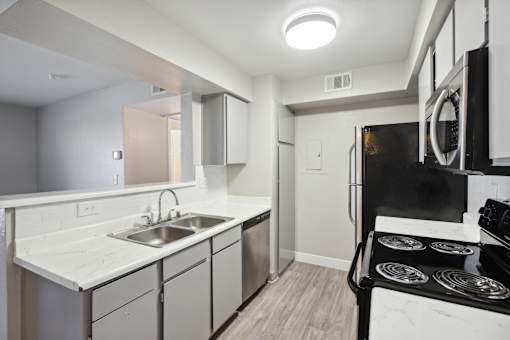 A modern kitchen with a black stove top oven.