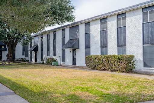 A white building with black awnings and windows.