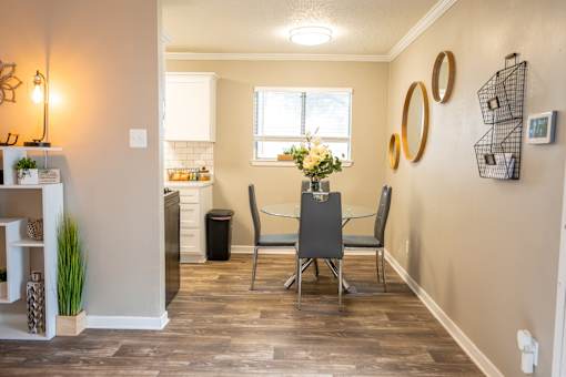 A dining room with a table and chairs.