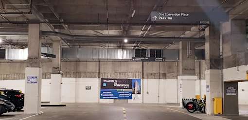 A parking garage with a sign that says "Convention Place Parking.".