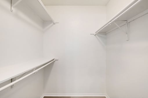 Empty white shelves in a room.