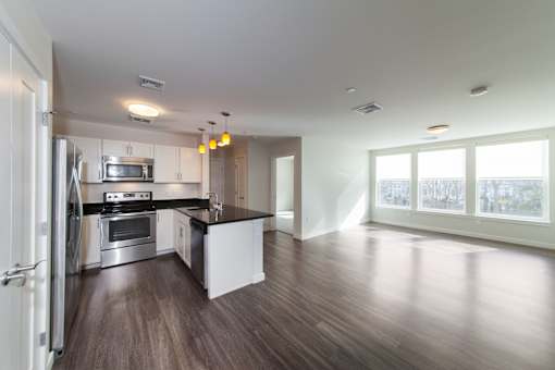 A modern kitchen with stainless steel appliances and a large island.