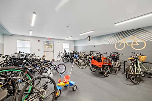 A room full of bicycles and a small toy truck.