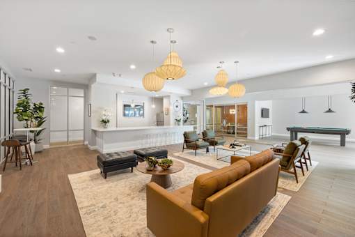 A modern living room with a brown sofa and wooden floors.