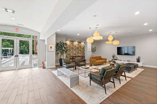 A living room with a white wall and a TV on the wall.