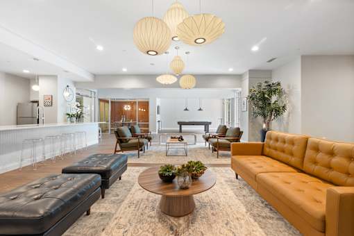 A living room with a brown coffee table and a yellow sofa.