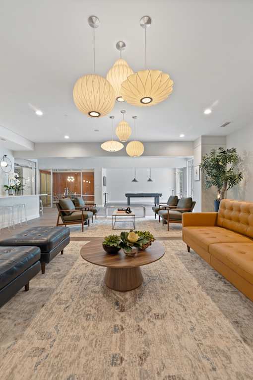 A modern living room with a coffee table in the center and a yellow sofa.