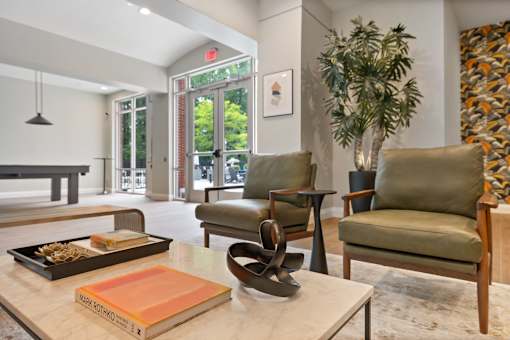 A living room with a green chair and a book by Mark Rothko.