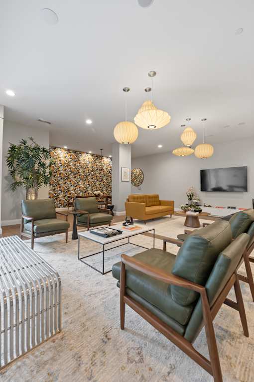 A living room with a green sofa and a yellow sofa.