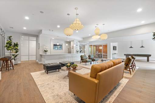 A living room with a brown sofa and a white ceiling.