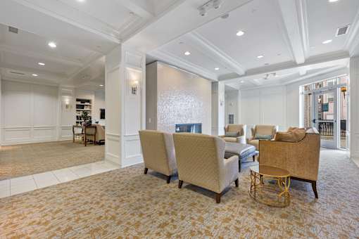 A living room with a large rug and a sofa.