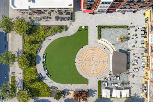 A circular labyrinth is in the middle of a park.