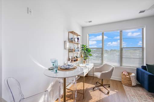 A dining room with a white table and chairs.