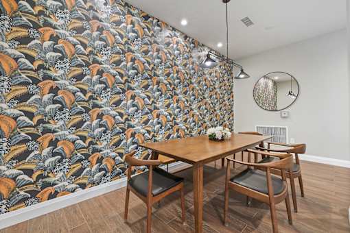 A dining room with a wooden table and chairs.