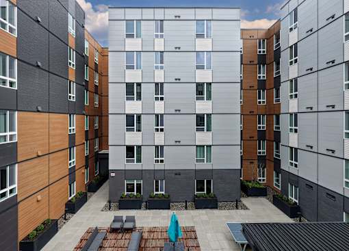 A modern apartment complex with a courtyard in the middle.