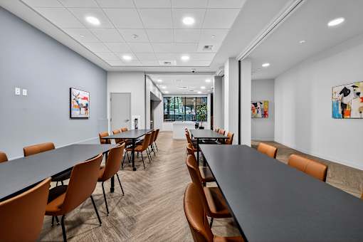 A conference room with a long table and chairs.