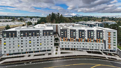 A large, modern building with a curved driveway in front.