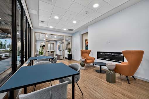 A conference room with a long table and chairs.