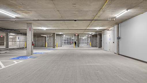 A large, empty parking garage with a concrete floor and walls.