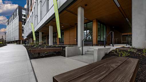 A modern building with a wooden bench in front of it.