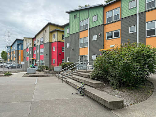 A colorful apartment complex with a bicycle parked in front.