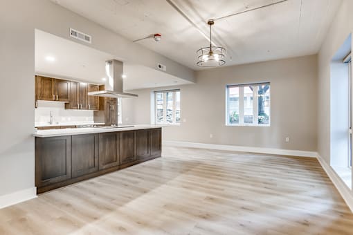 A spacious kitchen with wooden floors and a large island.
