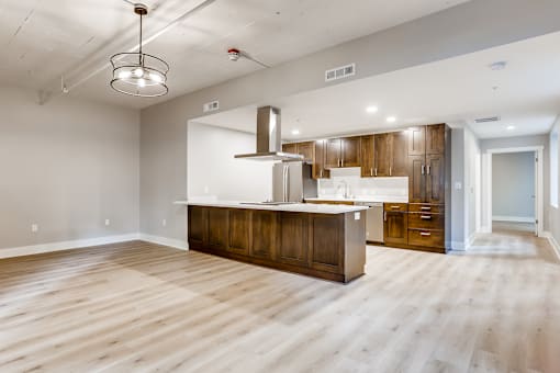 A kitchen with wooden floors and a large island.
