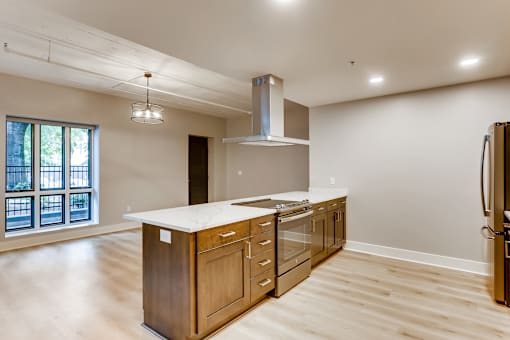 A kitchen with wooden cabinets and a large island.