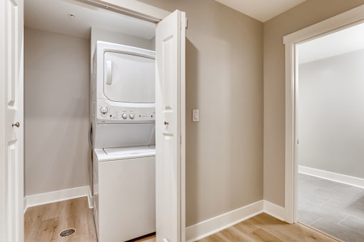 A small white oven and microwave are built into a wall in a kitchen.