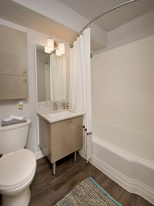 A white toilet sits next to a sink in a bathroom.