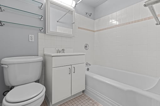 A white toilet sits next to a sink in a bathroom.