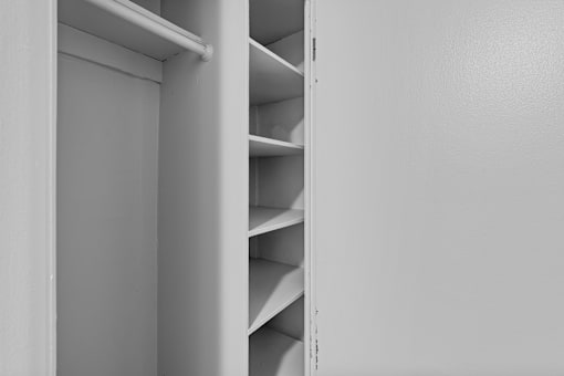 A white shelving unit with several shelves.