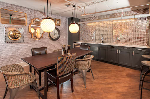 A dining room with a wooden table and chairs.