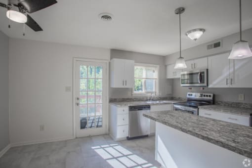 a kitchen with a stove top oven next to a doorway
