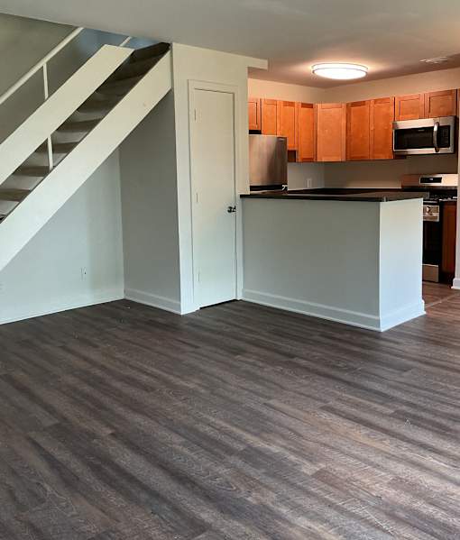 A kitchen with wooden floors and white walls.