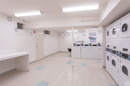 A laundry room with washers and dryers.