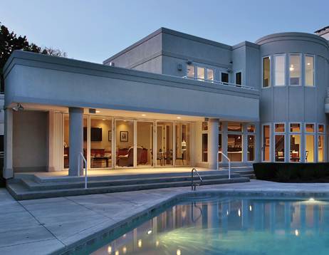 A modern house with a pool in the backyard.