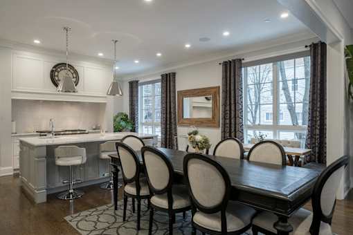 A modern kitchen with a dining table set for four.