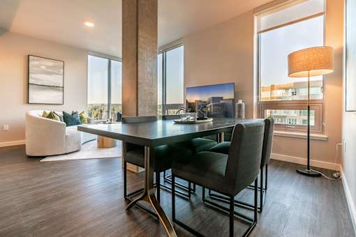 A modern dining room with a large table and chairs.