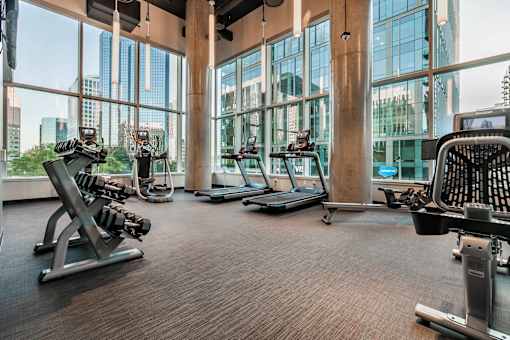 A gym with treadmills, weights, and exercise equipment.