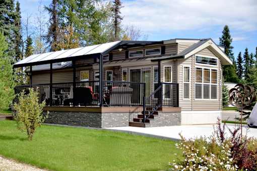 A house with a metal roof and a balcony.