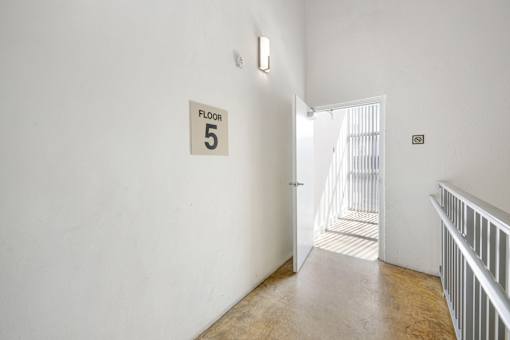 A hallway with a sign that says "Floor 5".
