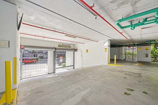 A parking garage with a sign that says "SLOW".